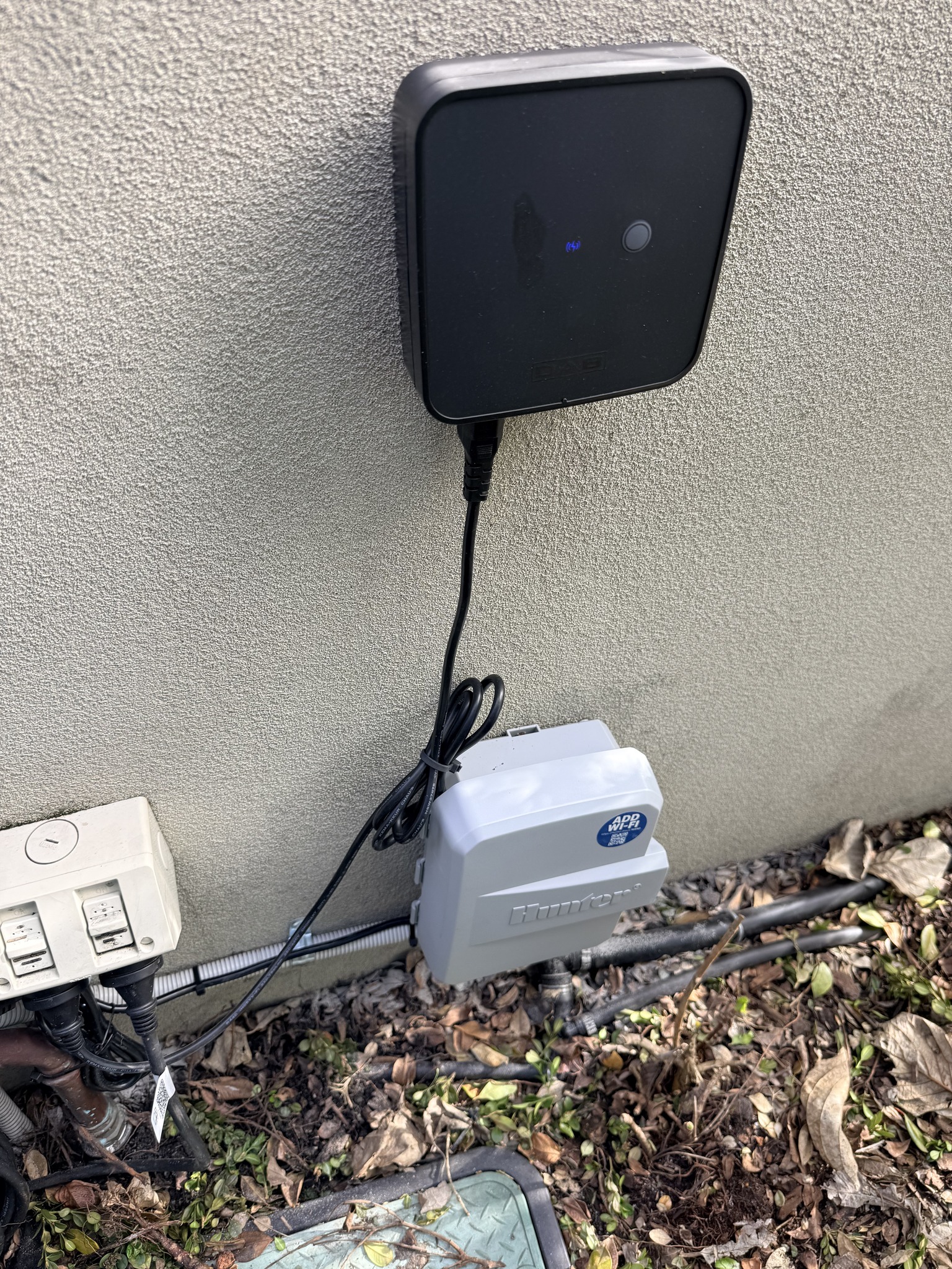 Installed irrigation controller mounted on the exterior wall.